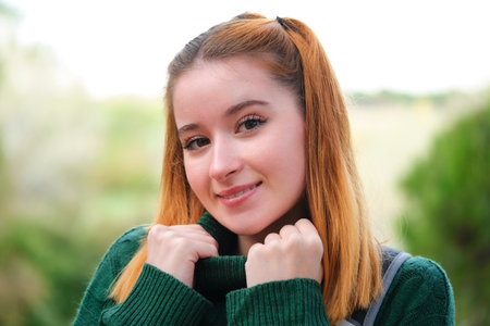 Portrait of smiley redhead young woman posing looking at camera in the mountain.の写真素材