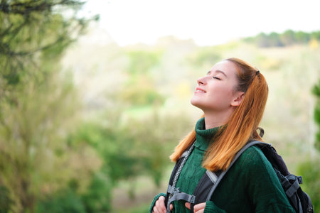 Female hiker breathing fresh air in the mountain. Trekking concept.の写真素材