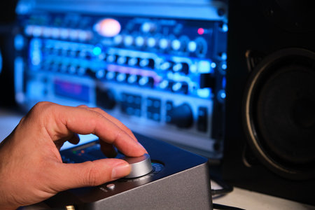 Close up of a musician hand adjusting the sound with equalizer. Music production.の写真素材