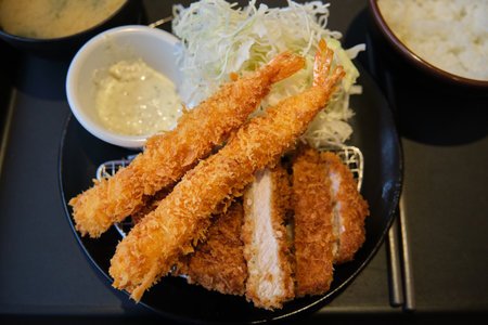 Tonkatsu set with prawn. Panko breaded deep fried pork cutlet served with shredded cabbage.の写真素材