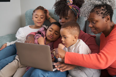 Happy african horizontal extended family having a good time in front of the laptop at home.