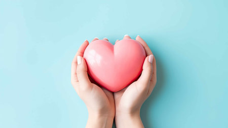 Health insurance, hands holding a heart over pastel blue background. Generative AI.の素材