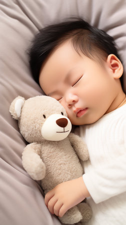 Newborn Asian baby boy sleeping with a teddy bear. Generative AI.の素材