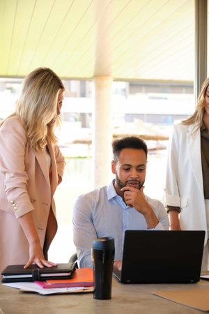 African business man discussing economic results with his female colleagues at office.の写真素材
