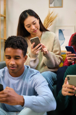 Asian woman using the smartphone at home with friends.