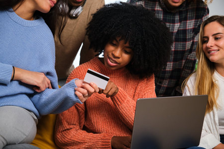 Cuban woman buying online with her friends in a laptop. Trip tickets reservation.