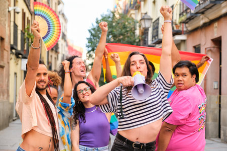 LGBTQ people with rainbow flags and a megaphone fighting for their rights. They are all smiling and...