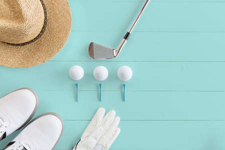 Golf club, golf balls Golf shoes and tees on a wooden surface in turquoise, top view, copy spaceの写真素材