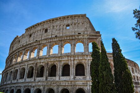 Colosseum or Coliseum in summer, Rome, Italy. Roman Colosseum is one of the main travel attractions of Rome. Ruins of Colosseum in sunlight. Sunny scenic view of ancient Colosseum. UNESCO site.の写真素材