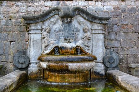 BERCHTESGADEN, GERMANY - Historic town of Berchtesgaden, fountain at the wallの写真素材
