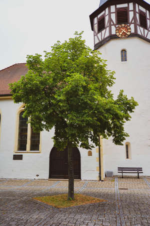 View over an traditional German village church with bare trees.の写真素材