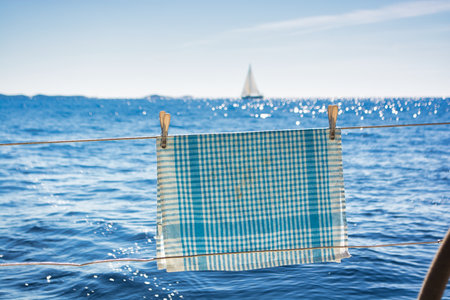 Blue and white dishcloth drying on a boat in Croatiaの写真素材