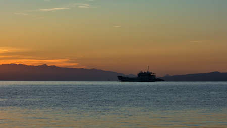 Beautiful colours of Sunset in Dalmatia, Croatia with yachts on the seaの写真素材