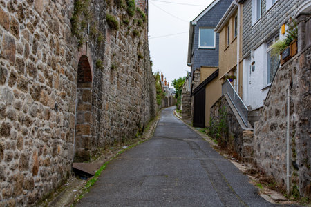 Narrow street with traditional stone houses in a coastal town of St Ives, Cornwall, United Kingdom .の写真素材