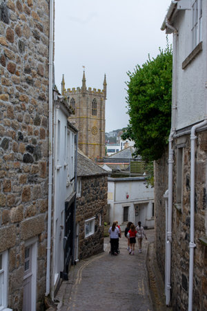 Narrow street with traditional stone houses in a coastal town of St Ives, Cornwall, United Kingdom .の写真素材