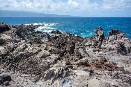 Rugged coastline at the tip of Makaluapuna Point in West Maui, Hawaii - Lava cliffs of Dragon's Point on the Kapalua Coastal Trailの写真素材