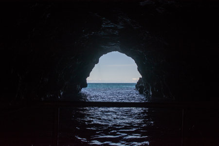 Large cave with clear fresh water near Kalalau Beach in the Na Pali Coast State Park on the island of Kauai, Hawaii USA.の写真素材