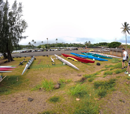 Hawaiian canoes with outriggers on the shore of Wailua River on Kauai, Hawaiiの写真素材
