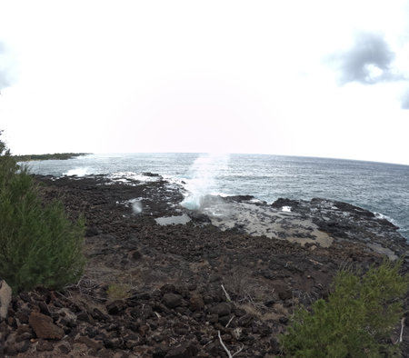 Spouting Horn blowhole against bright blue tropical ocean in Kauai, Hawaiiの写真素材