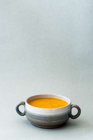 Carrot ginger soup in a bowlの写真素材