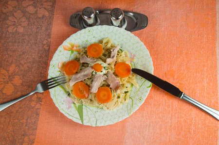 Noodles, chicken carrots on the plate. A healthy diet.の写真素材