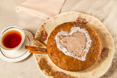Homemade cake and a Cup of tea on light background.
