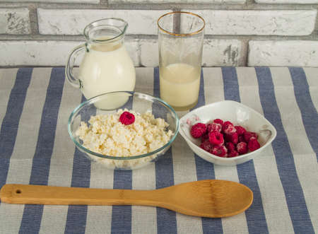 diet cottage cheese with fresh raspberries and milk.の写真素材