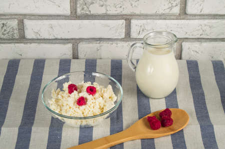 diet cottage cheese with fresh raspberries and milk.の写真素材
