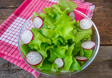 Healthy eating. Diet salad with radish, lettuce and olive oil.の写真素材