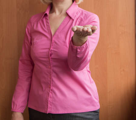 female holding an open palm hand up, presenting and showing something, selective focus.の写真素材
