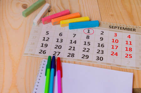 Back to school, calendar, colored chalk on wooden background.の写真素材