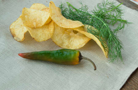Spicy potato chips with pepper and dill, place for your text.の写真素材