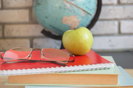 World teachers ' Day in school. Still life with books, globe, Apple glasses. selective focusの写真素材