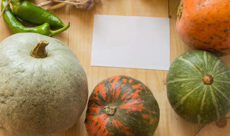 Harvest or Thanksgiving background with autumn fruits and gourds on a rustic wooden table