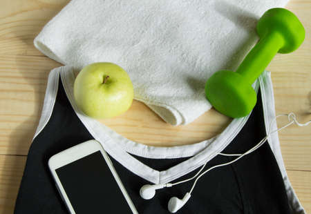 The concept of a healthy lifestyle. Apple, dumbbell towel t-shirt.