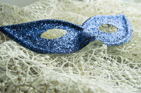 Brilliant blue carnival mask lies on beautiful lace. Fashion backgroundの写真素材