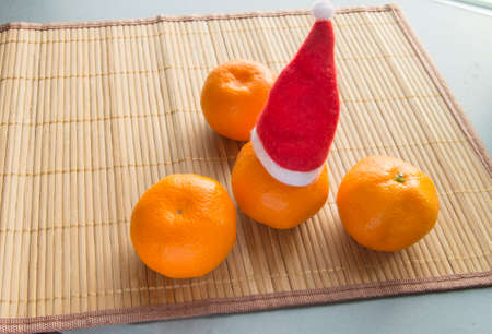 Chinese New year Mandarin hat on a bamboo Matの写真素材