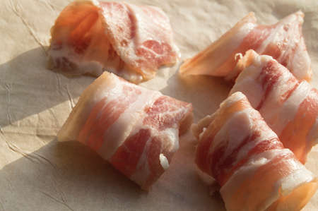 Slices of bacon are rolled into the rolls on parchment
