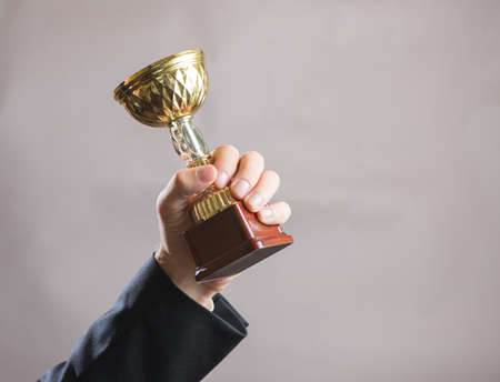 Hand of businessman holding Cup, concept successの写真素材