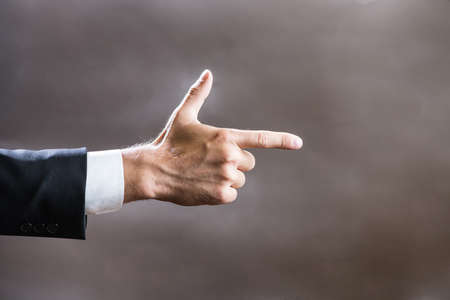 Hand of a business person points the index fingerの写真素材