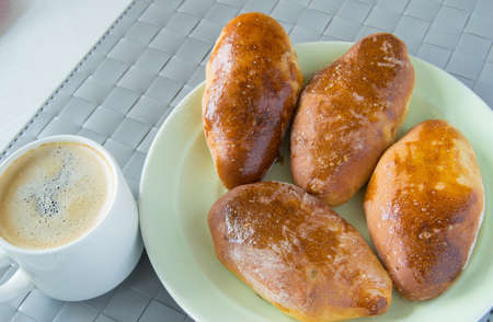 Cup of hot espresso and baked cakes on the plate.の写真素材