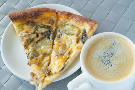 Delicious Breakfast, lunch - Cup of coffee and two slices of pizzaの写真素材