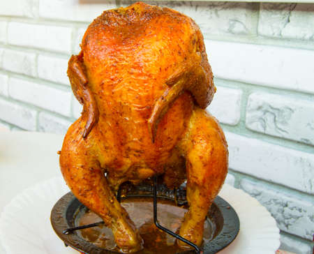 Delicious and tasty baked whole chicken grilled on the plateの写真素材