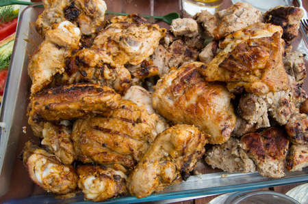 Tasty pieces of fried chicken on the grill.