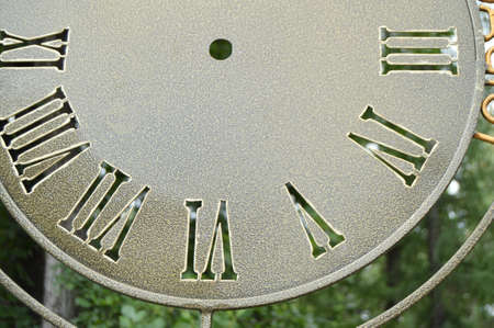 Part of the dial, vintage wall clocks, closeup dial with Roman numerals.