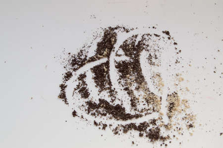 Brown and beige eye shadow scattered on white background, texture makeup with a painted heart.の写真素材