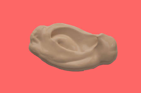 Foundation cream, liquid makeup, splash isolated on red backgroundの写真素材