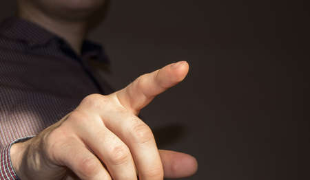 Businessman pointing finger at blank virtual screen by pressing a virtual button