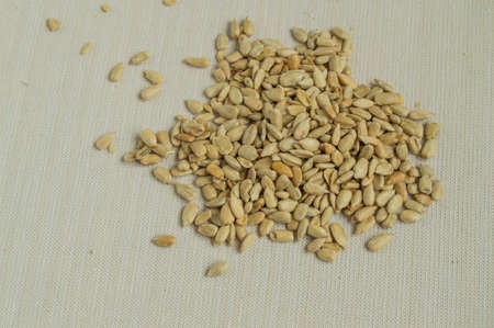 Sunflower seeds scattered on a table of linen tablecloths, the concept of healthy eating