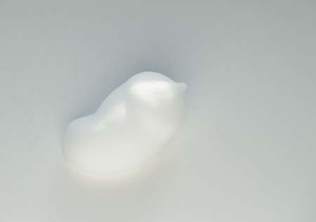 Drops of shaving foam, mousse or hair styling foam on white background